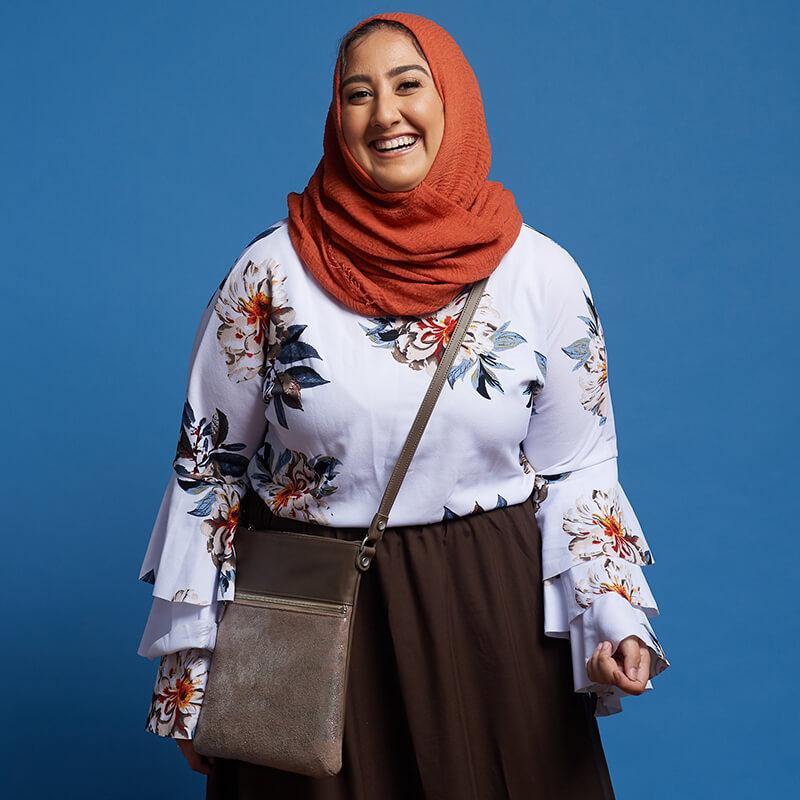 woman wears Laudi Vidni Aria Crossbody in Jet Set Taupe and Taupe.