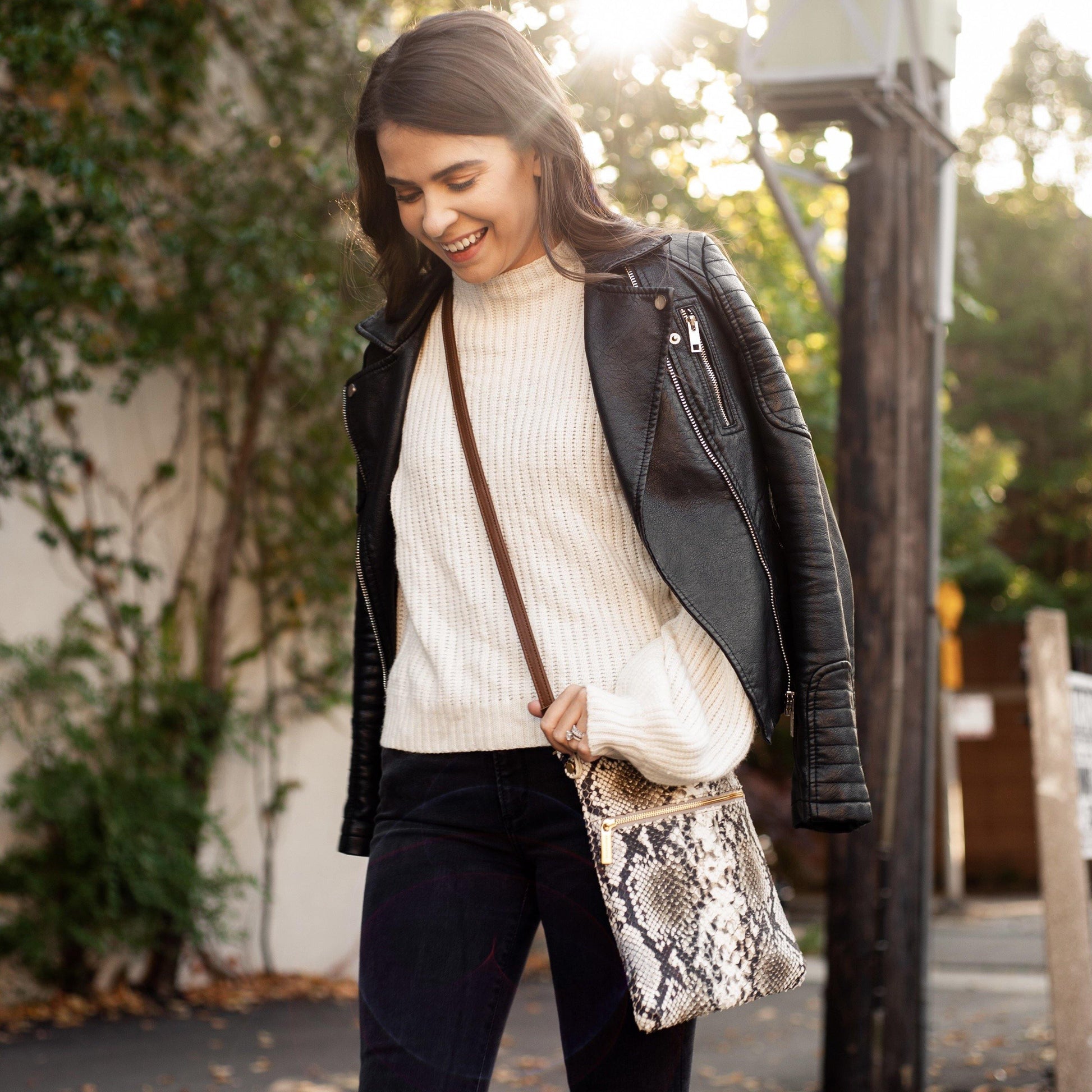 Woman wears Laudi Vidni Aria Crossbody in Snake Shadow.