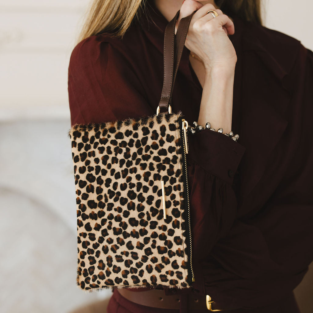 Grace Wristlet in Leopard/Espresso model holding