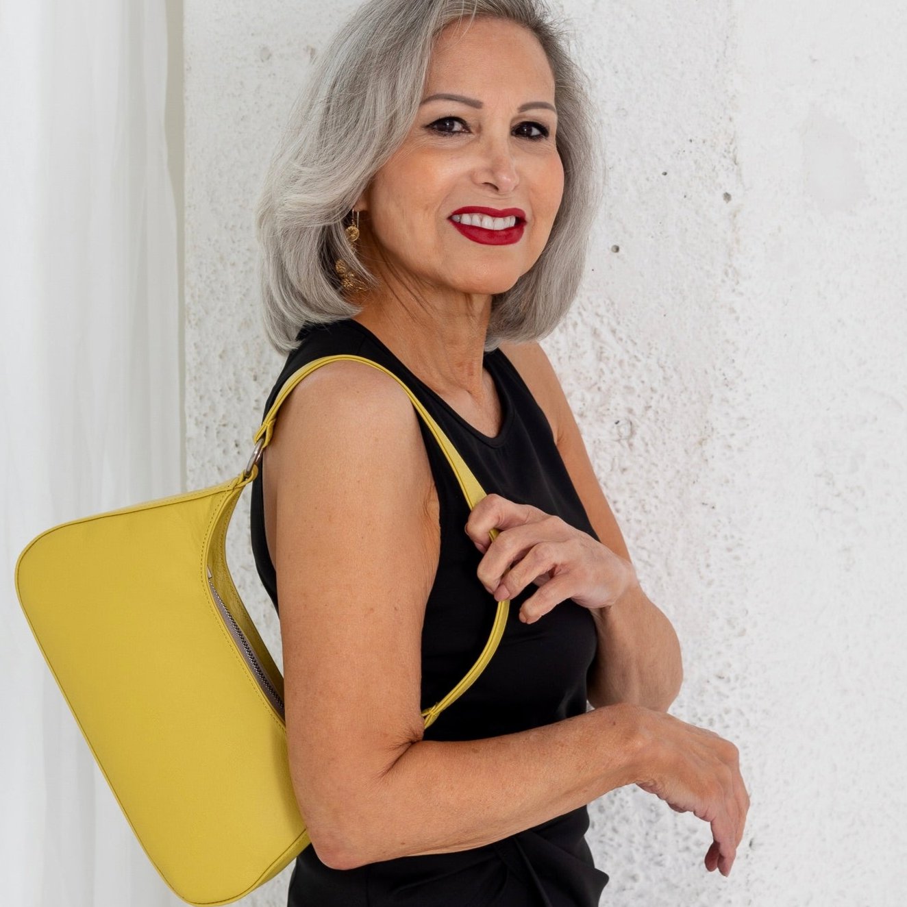 woman holding Laudi Vidni Harmony Shoulder Bag in yellow leather