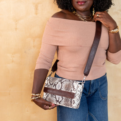 woman holding laudi vidni prima crossbody in embossed snake shadow and espresso leathers