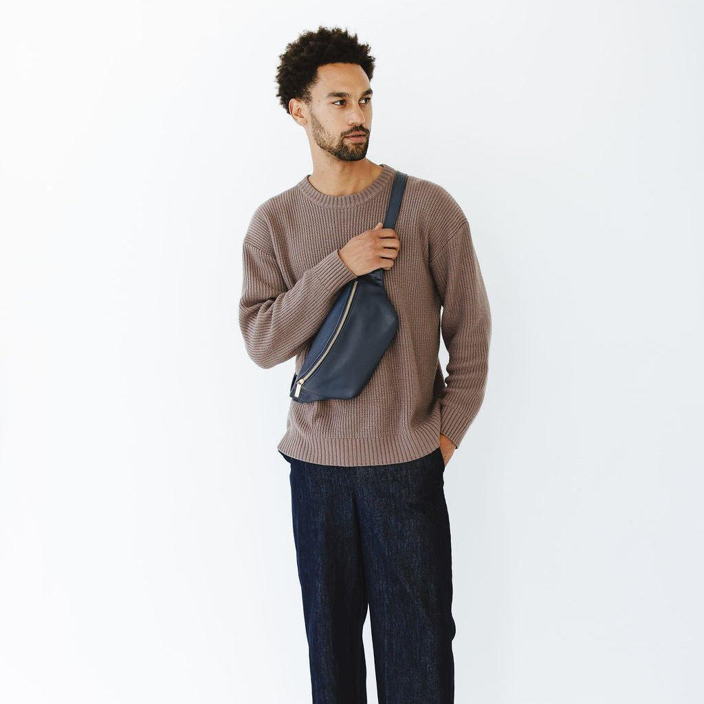 New Belt Bag in Indigo Leather on Model holding strap