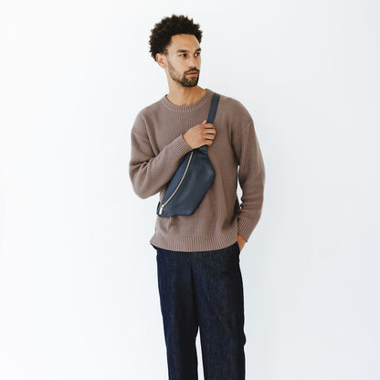 New Belt Bag in Indigo Leather on Model holding strap