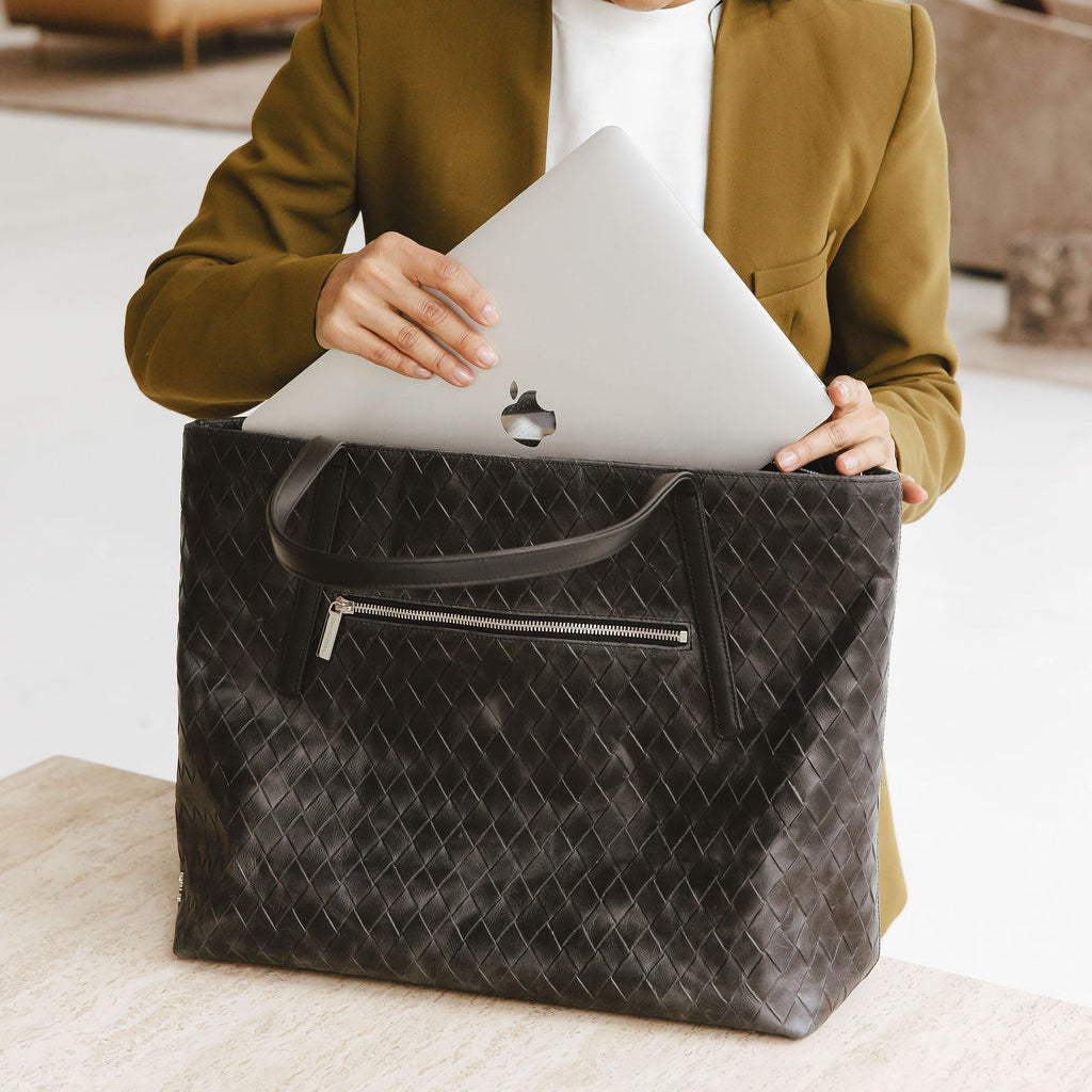 Opus Large Tote in Basketweave Black Model Putting Laptop in Bag