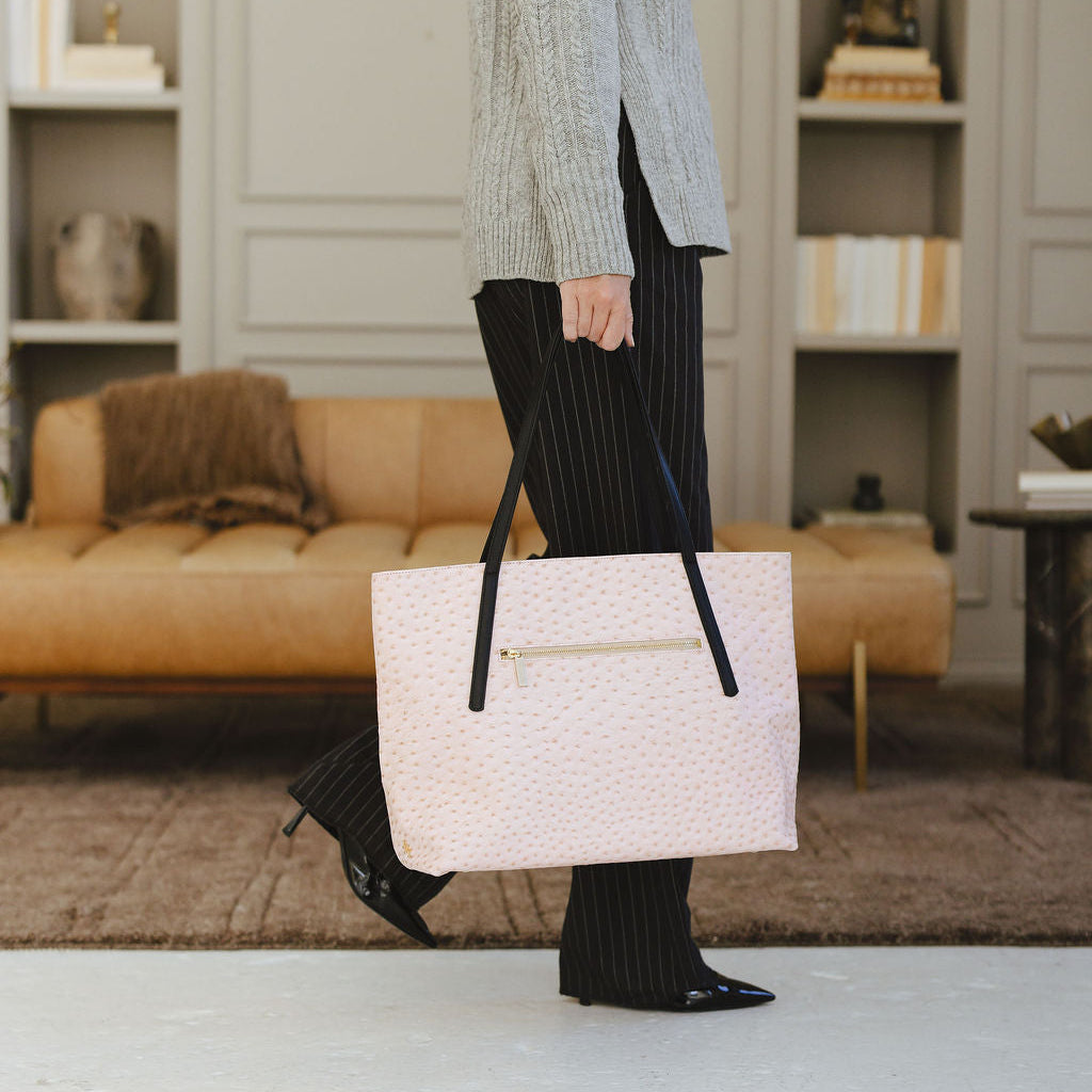 Opus Large Tote in Ostrich Pink/Black on model holding straps
