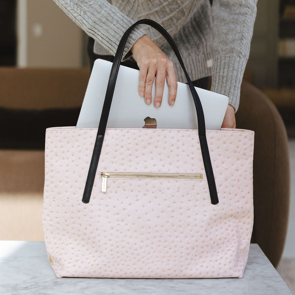 Opus Large Tote in Ostrich Pink/Black on table with laptop