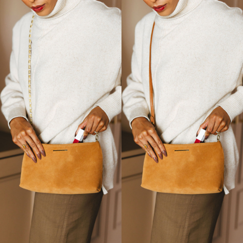 Vivace in Suede on Model Putting Lip Gloss with Chain and Leather Strap