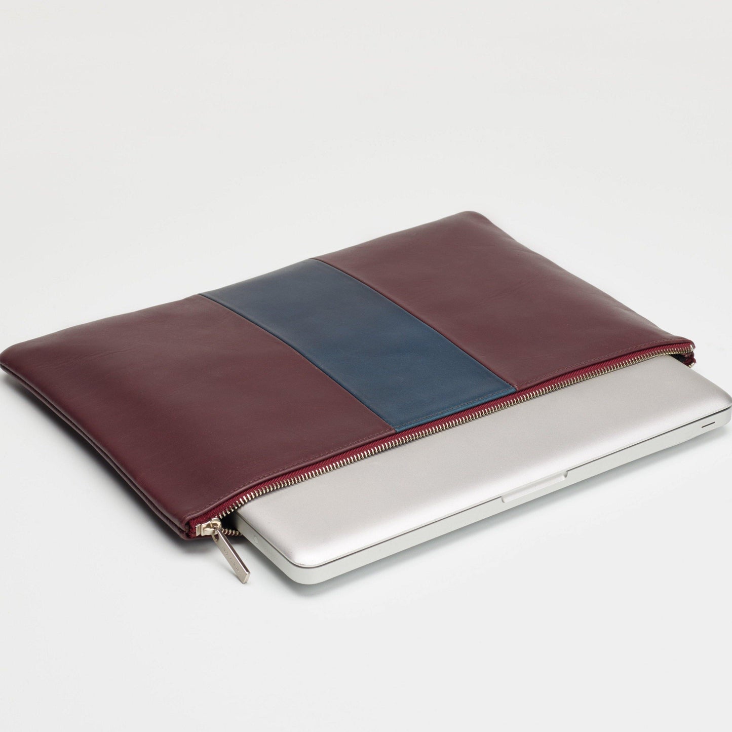 computer showing inside a Laudi Vidni leather laptop sleeve in oxblood and navy leathers